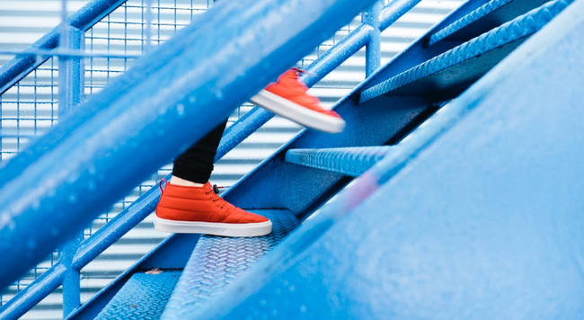 Red sneakers going up the stairs